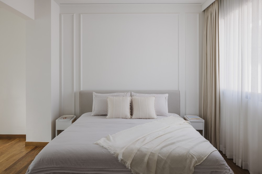 minimalist bedroom with parquet floor and feature wall