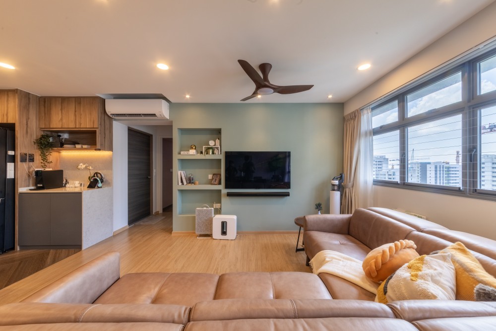 modern living room with bookshelf and ceiling fan