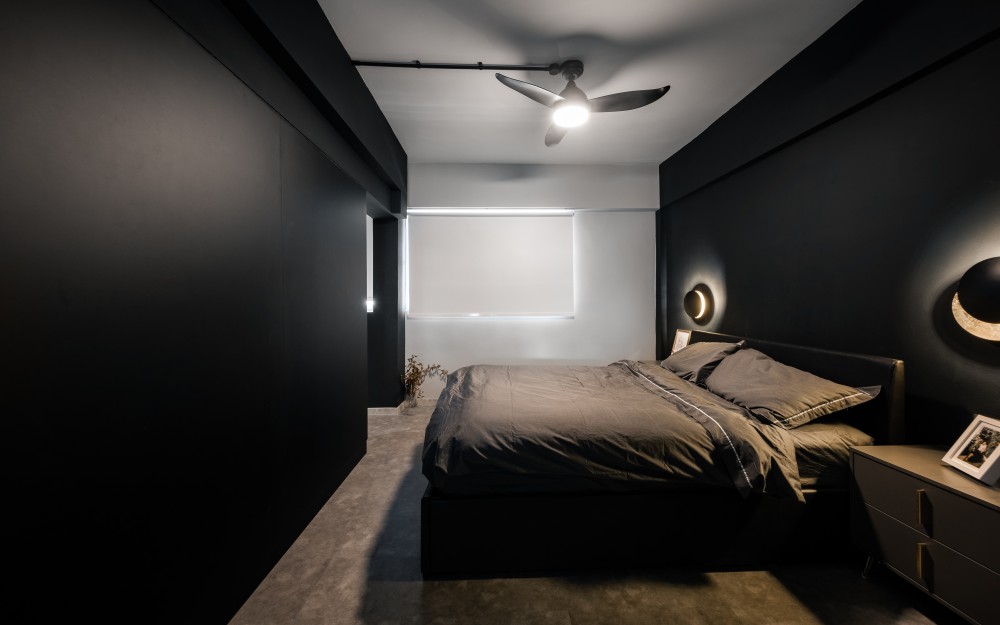 industrial bedroom with ceiling fan and storage cabinets