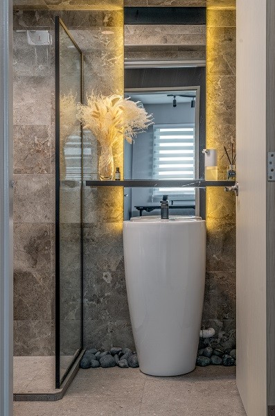 modern bathroom with homogeneous tiles and mirror