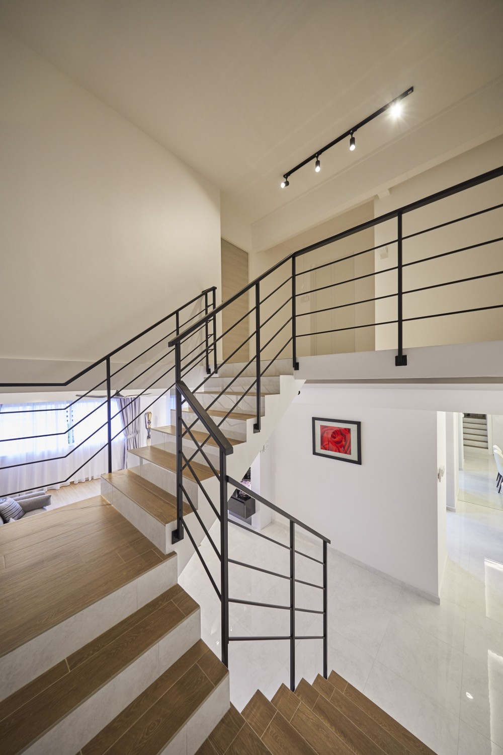 modern bedroom with staircase and paintings