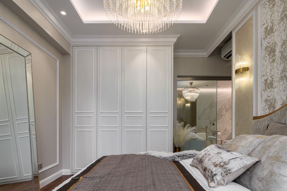 modern bedroom with wardrobe and chandelier