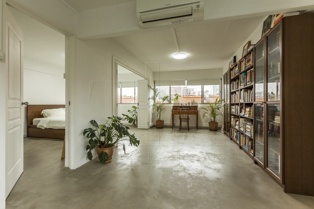 contemporary study with bookshelf and cement floor