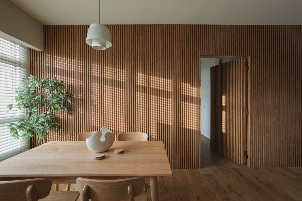 modern dining room with wood flooring and feature wall