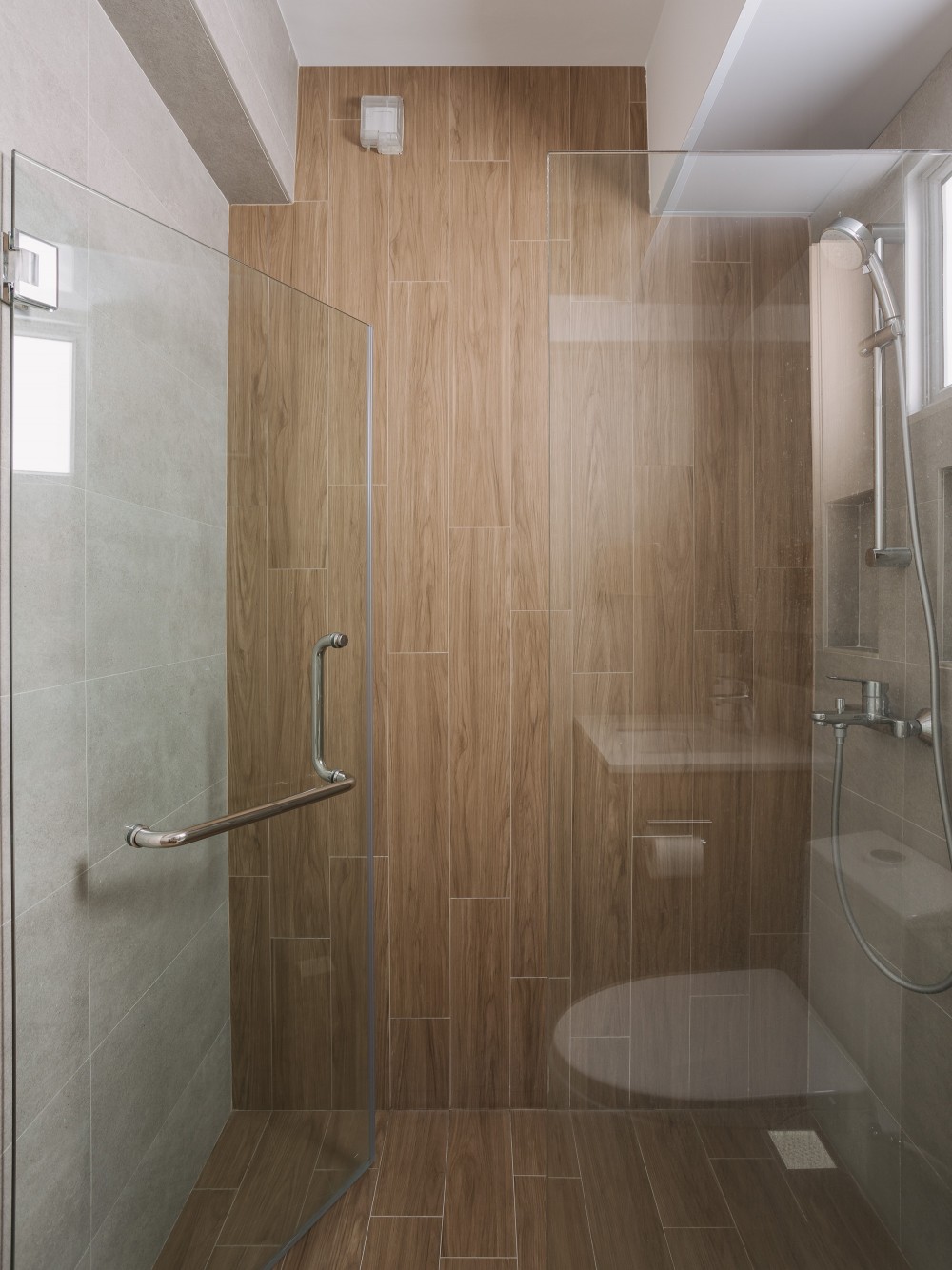 modern bathroom with wood flooring and shower screen