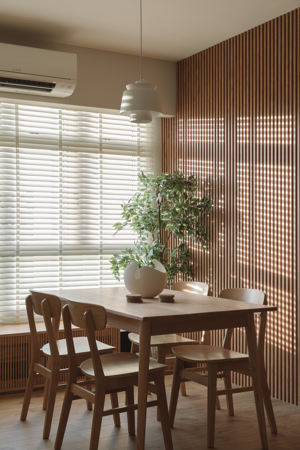 modern dining room with feature wall and drop light