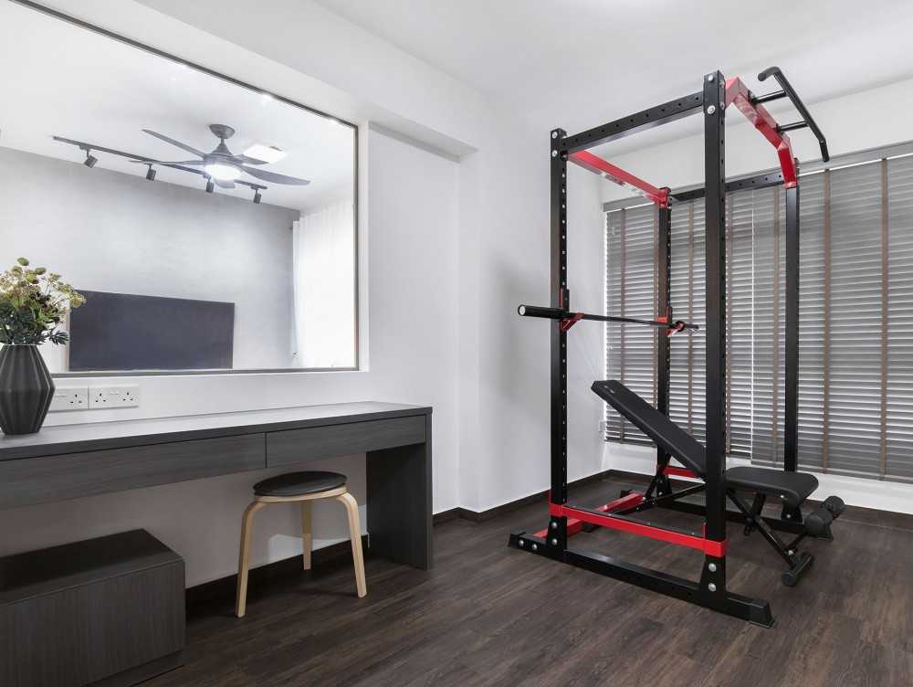 modern home gym with seating bench and gym equipment