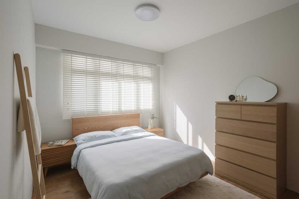 modern bedroom with wood flooring and ceiling light