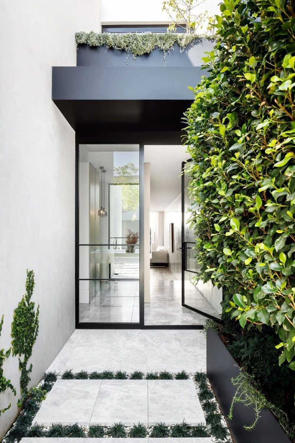 contemporary entryway with homogeneous tiles and marble floor