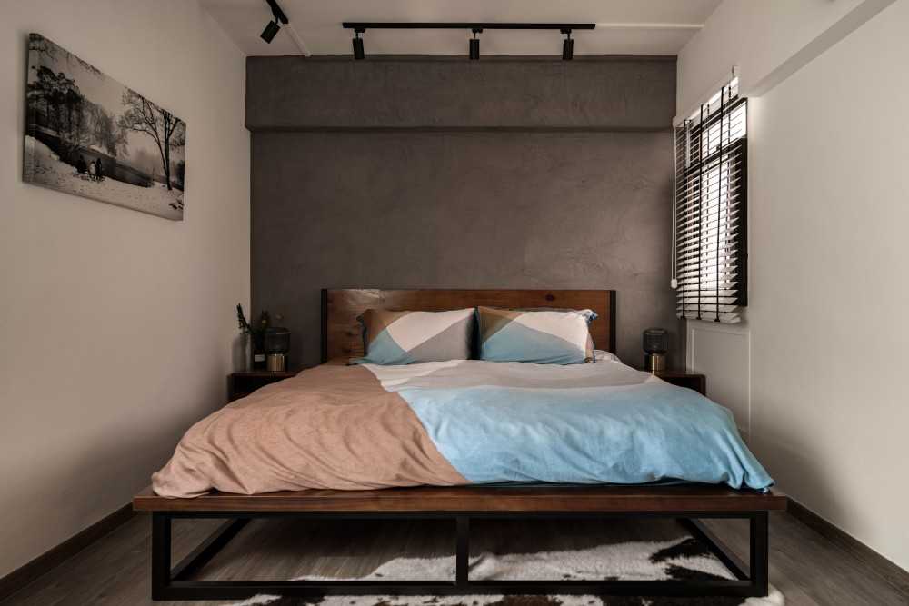 industrial bedroom with bedside table and paintings