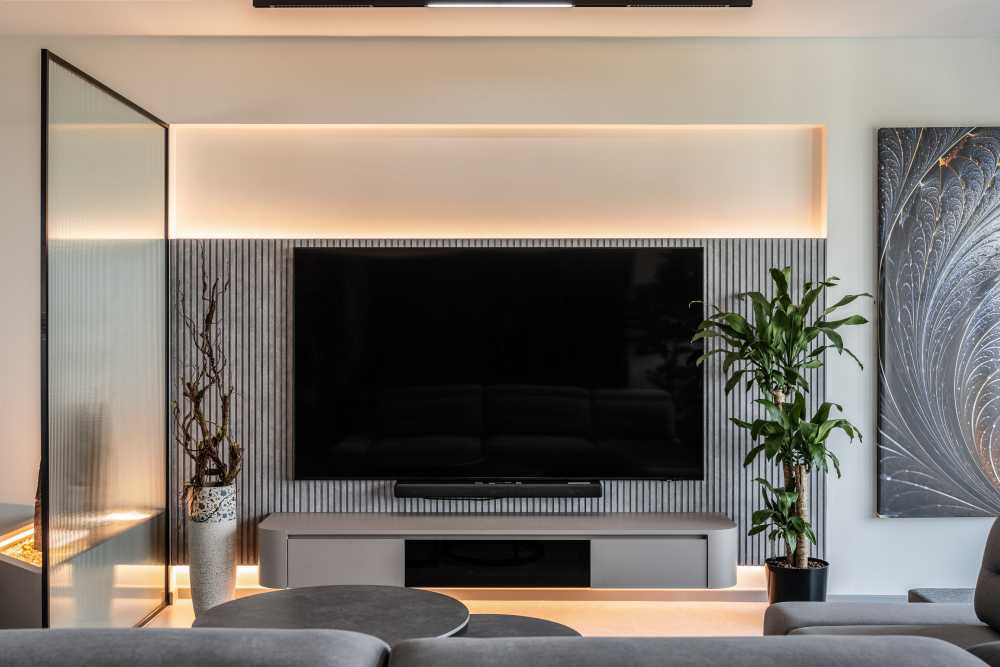 contemporary living room with feature wall and tv