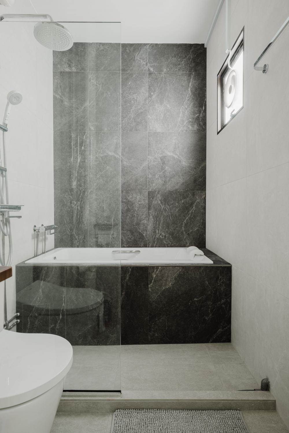 scandinavian bathroom with bathtub and toilet bowl