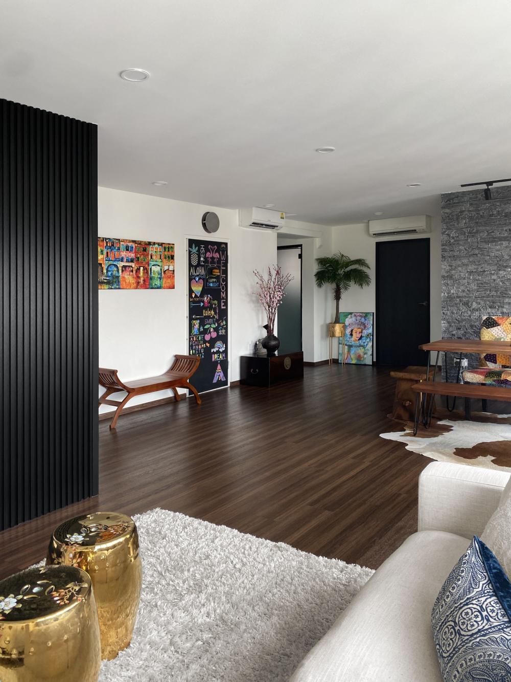 eclectic living room with vinyl flooring and feature wall