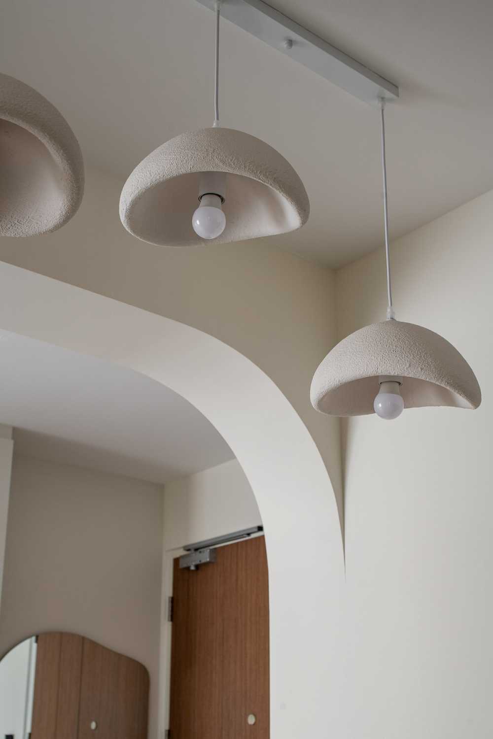 modern dining room with drop light and chandelier