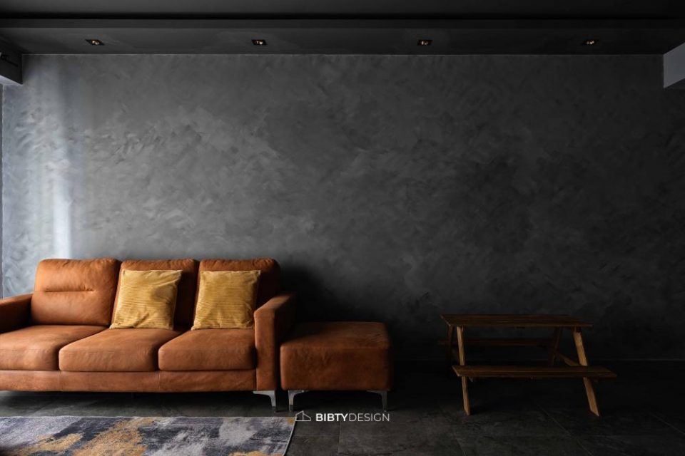 industrial living room with homogeneous tiles and feature wall