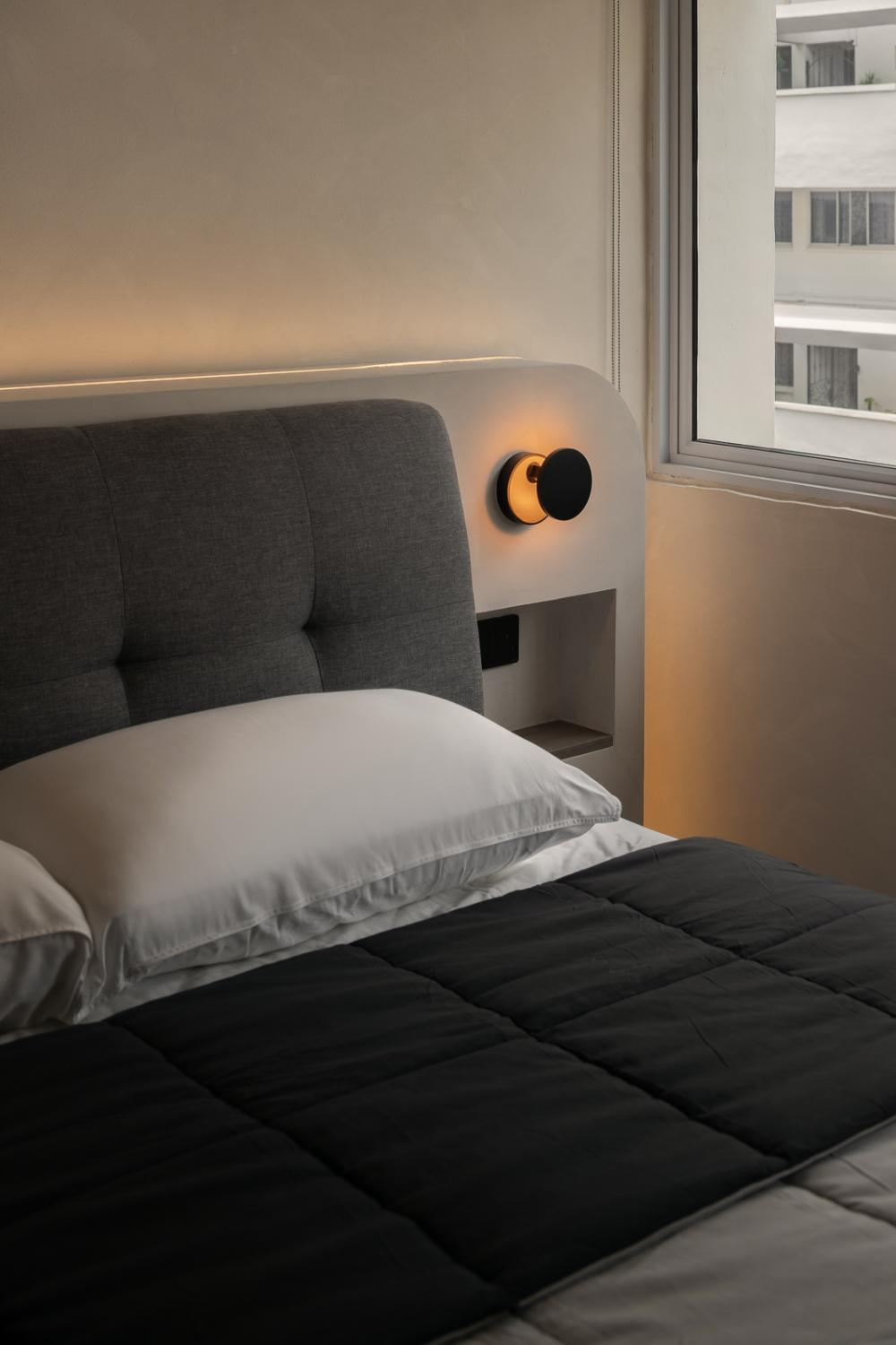 contemporary bedroom with feature wall and bedside table