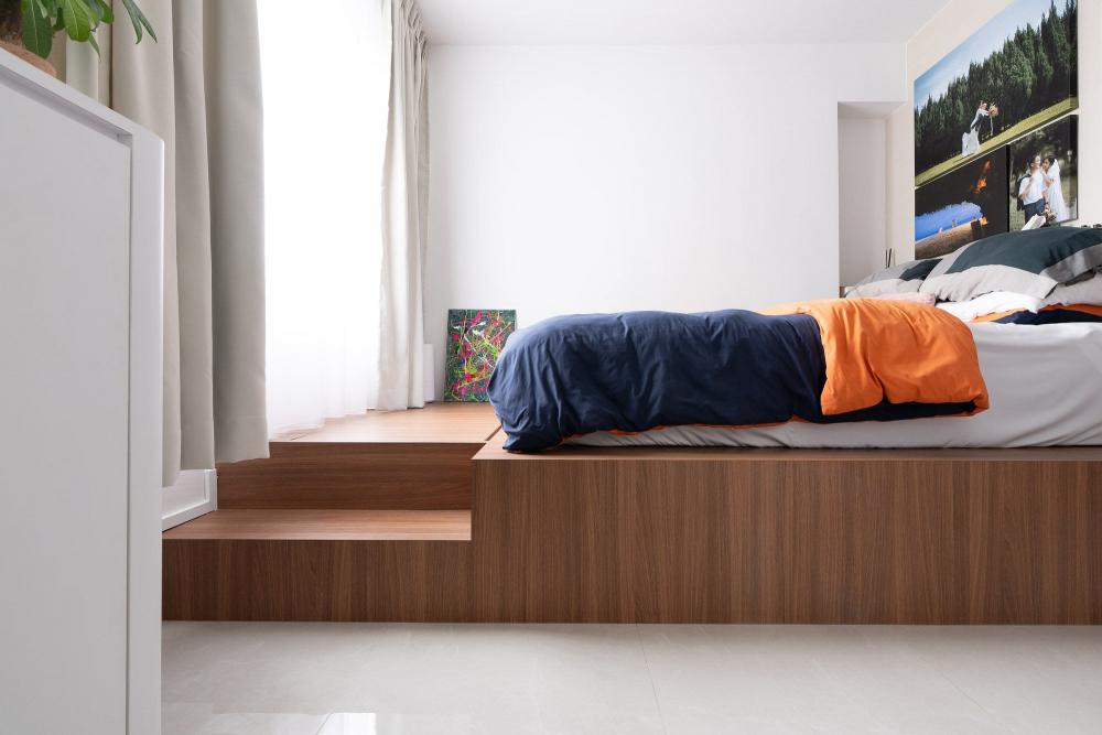 modern bedroom with built in bed and paintings